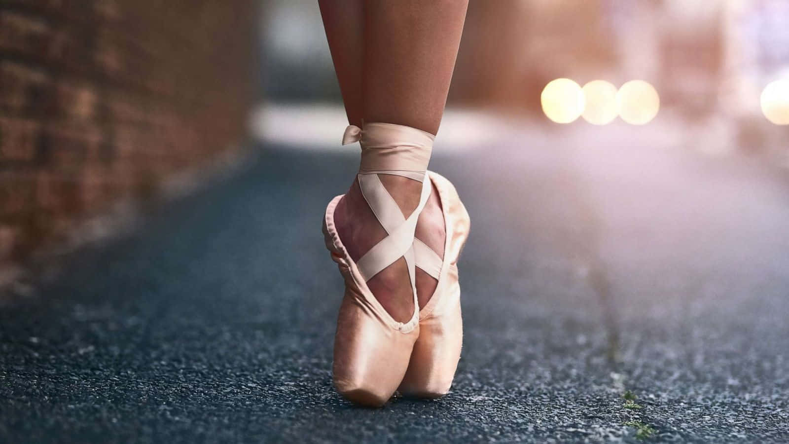 A Woman Wearing Ballet Shoes Walking Down The Street Background
