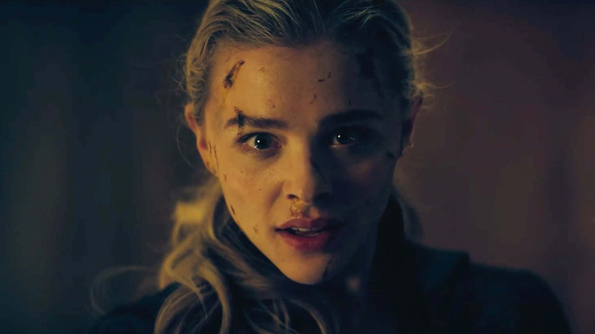 A Woman With A Bloody Face Is Staring At The Camera Background