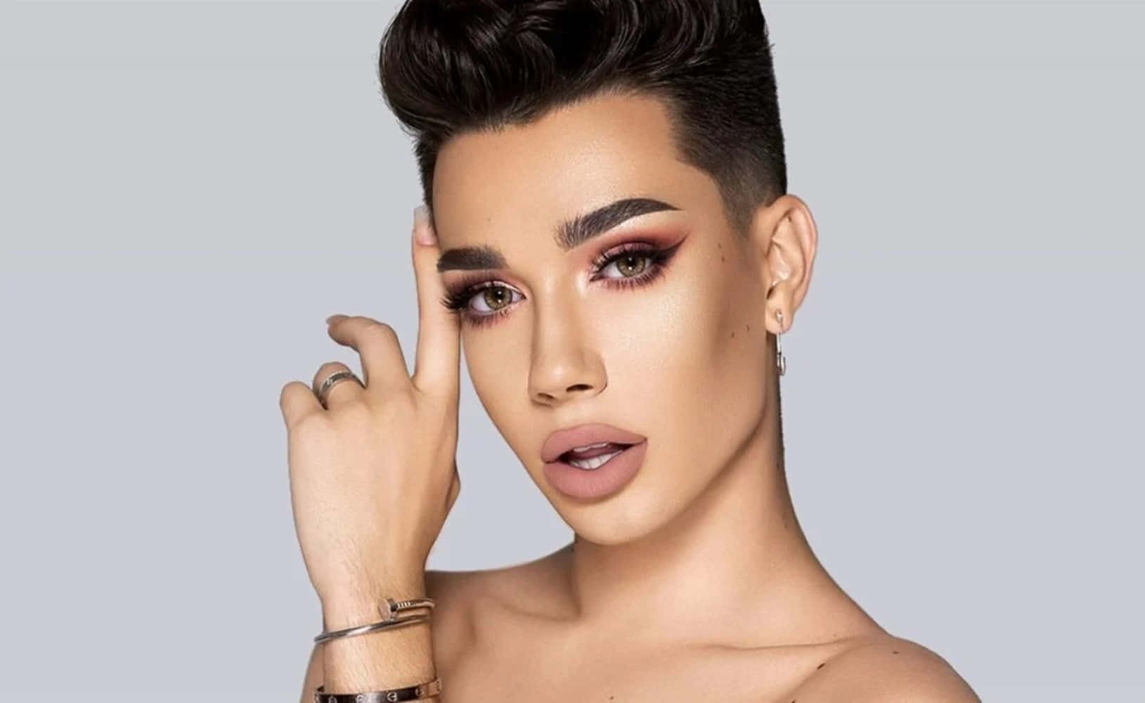 A Woman With A Short Hair And Makeup Background