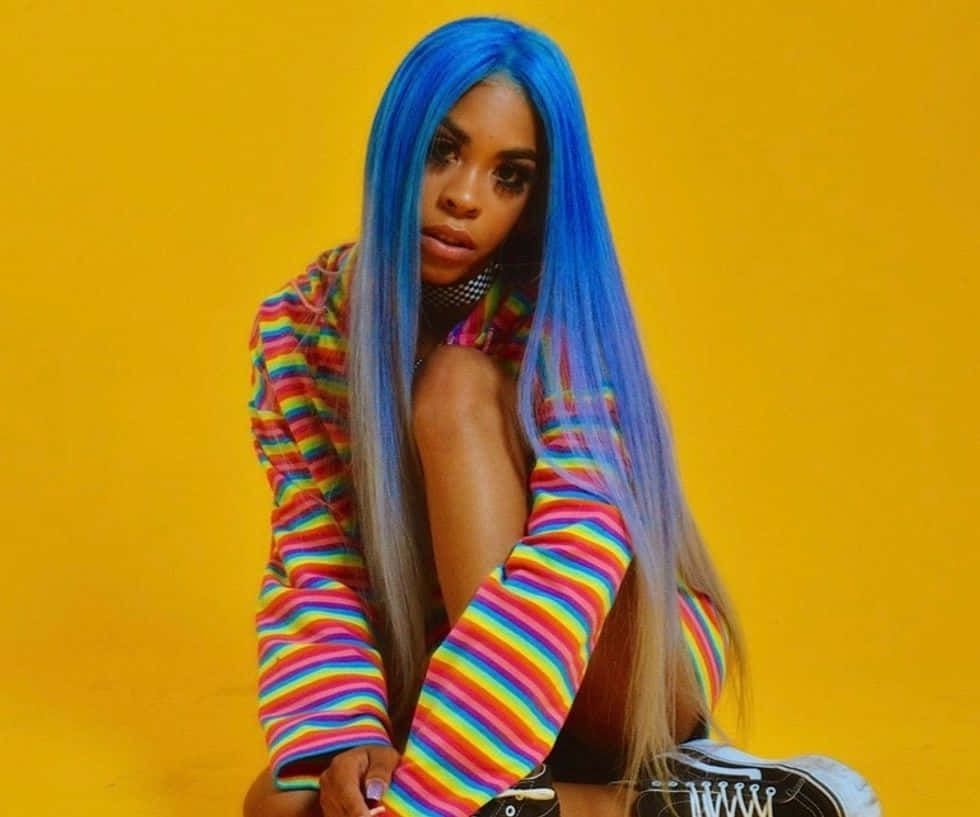 A Woman With Blue Hair Sitting On A Yellow Background Background