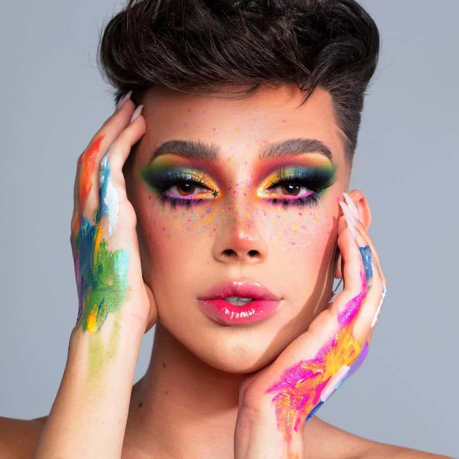A Woman With Colorful Makeup And Hand Painted Hands Background