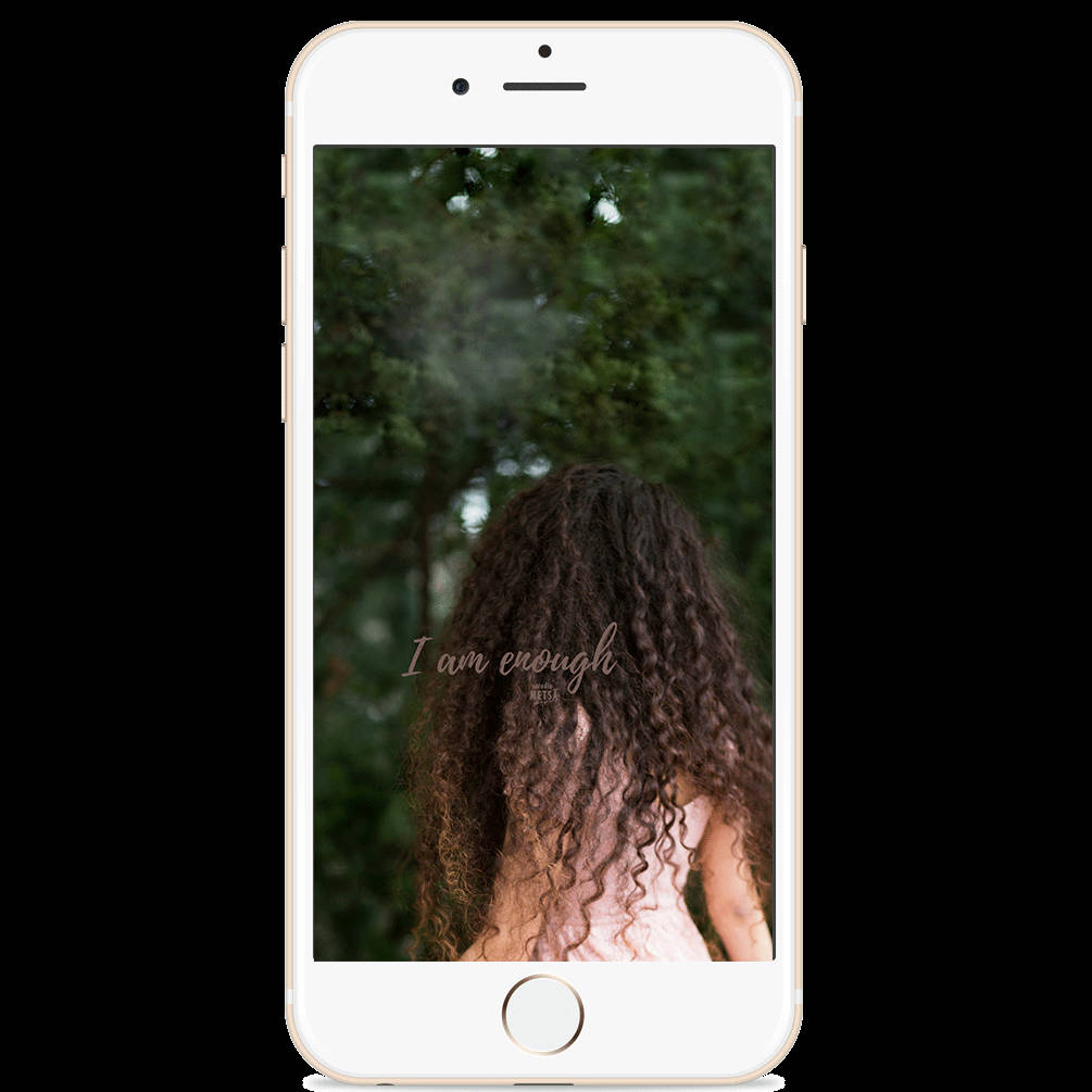 A Woman With Curly Hair Is Standing In Front Of A Tree Background