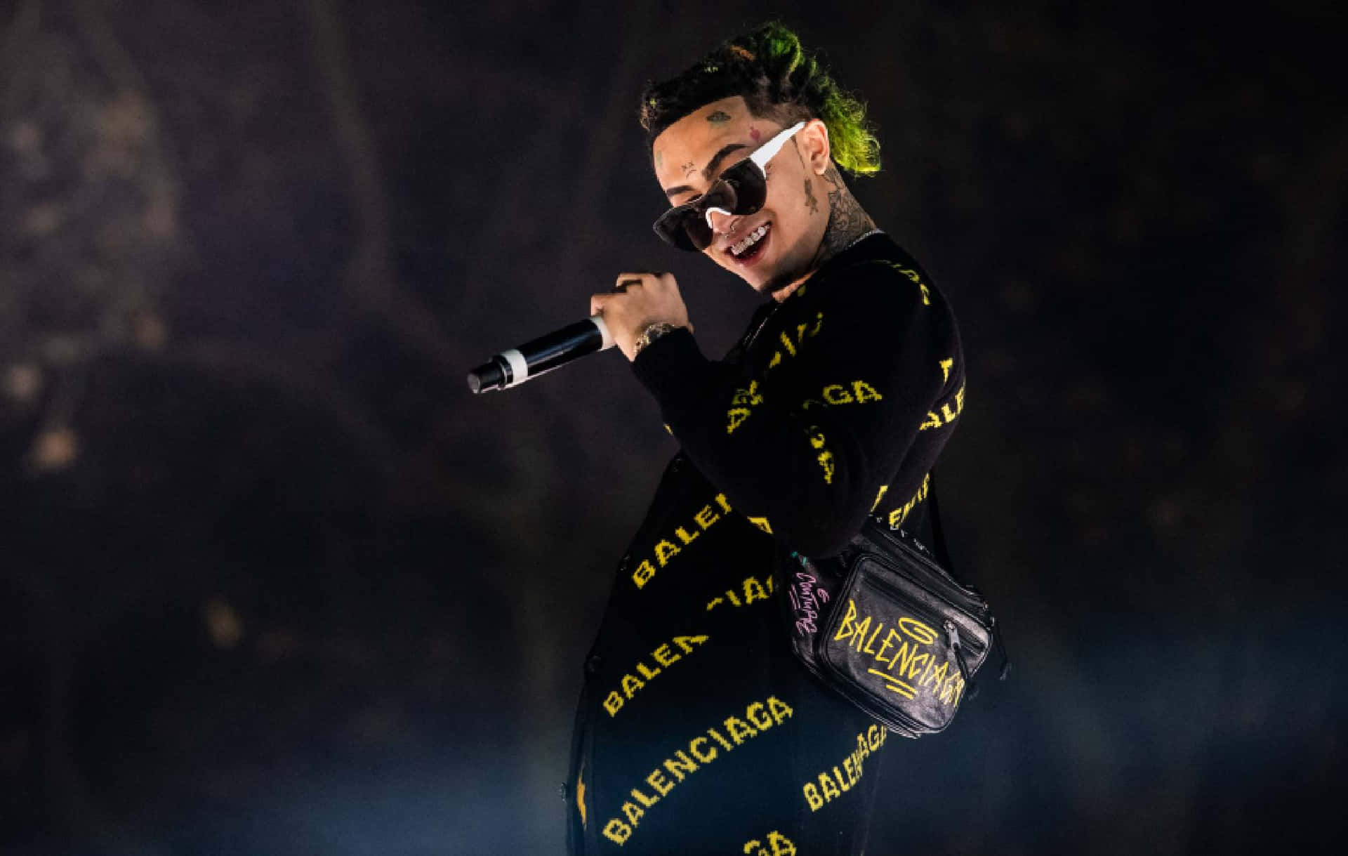 A Woman With Green Hair And A Microphone Background