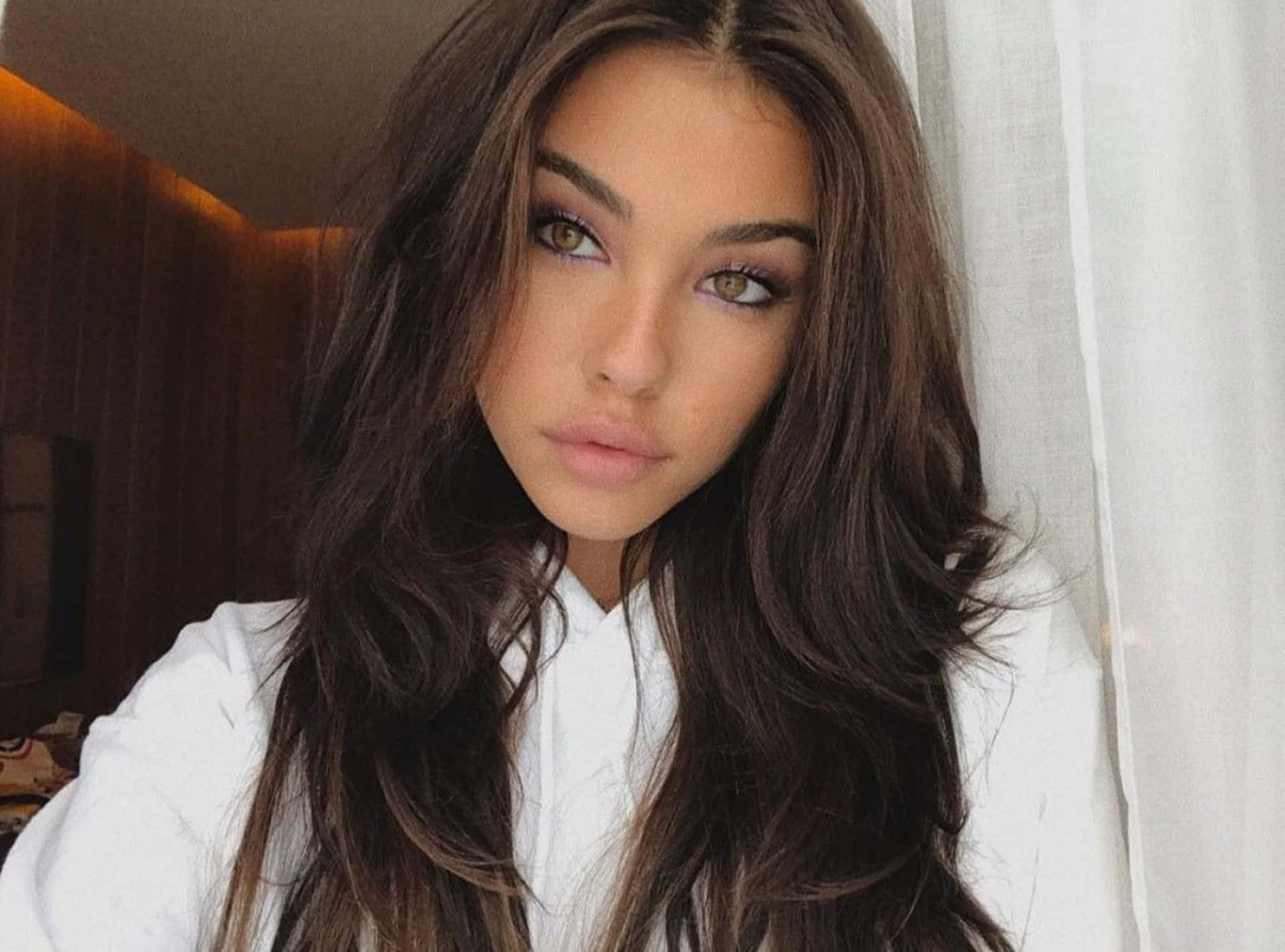 A Woman With Long Hair Is Posing For A Photo Background