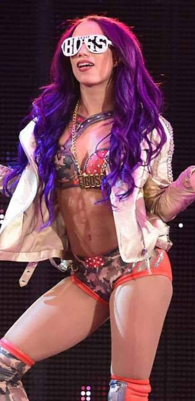 A Woman With Purple Hair And Sunglasses On Stage