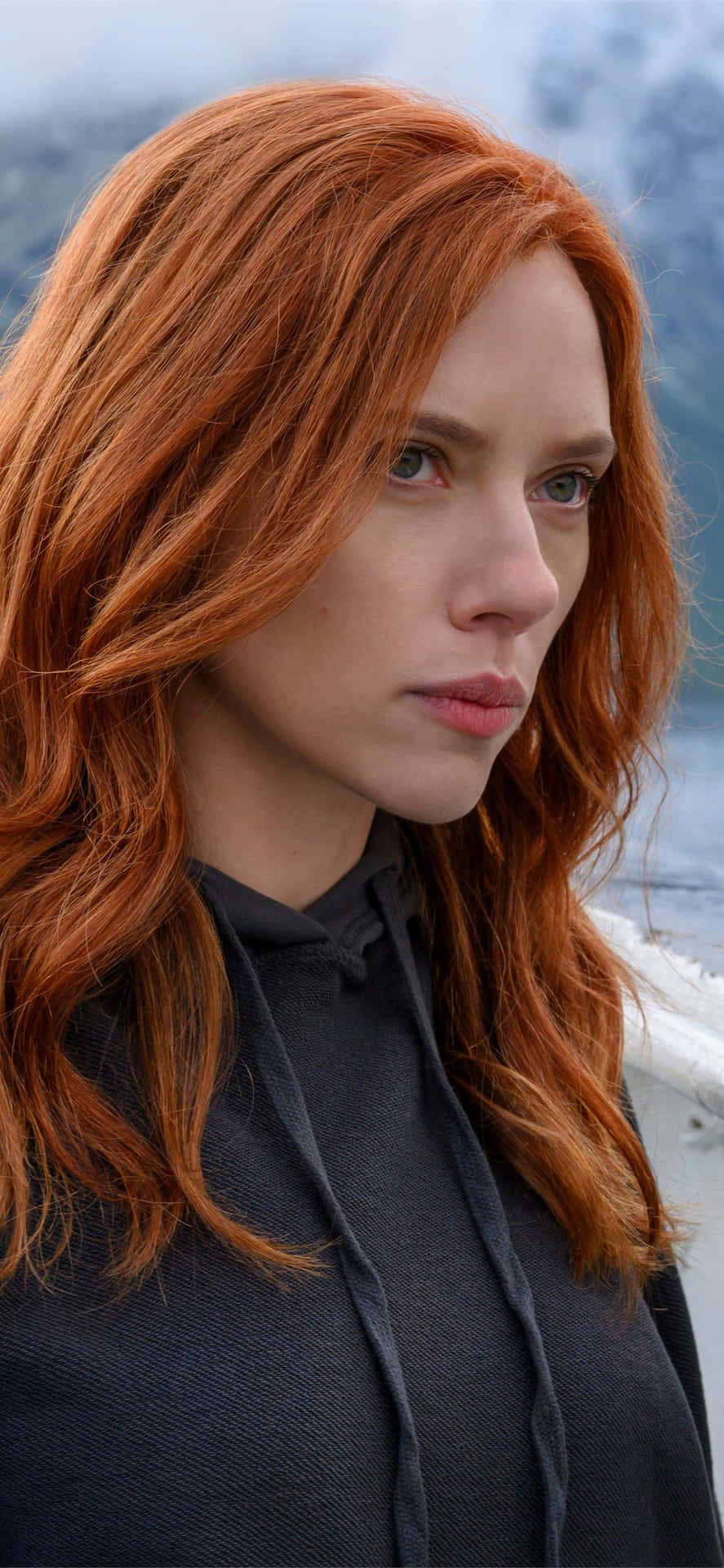 A Woman With Red Hair Standing On A Boat