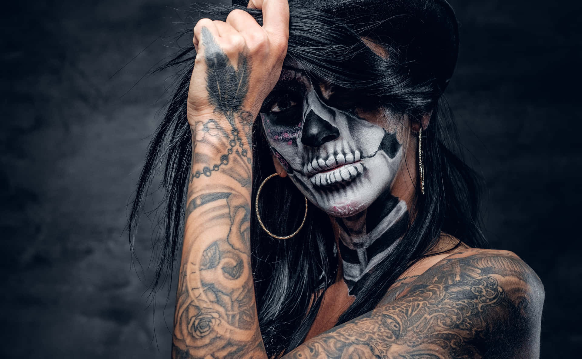 A Woman With Skeleton Makeup And Tattoos Background