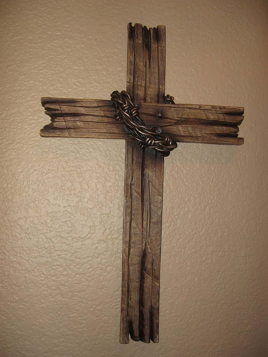 A Wooden Cross With A Chain Hanging On It Background