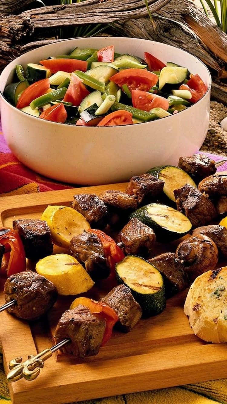 A Wooden Cutting Board With Skewers And Vegetables