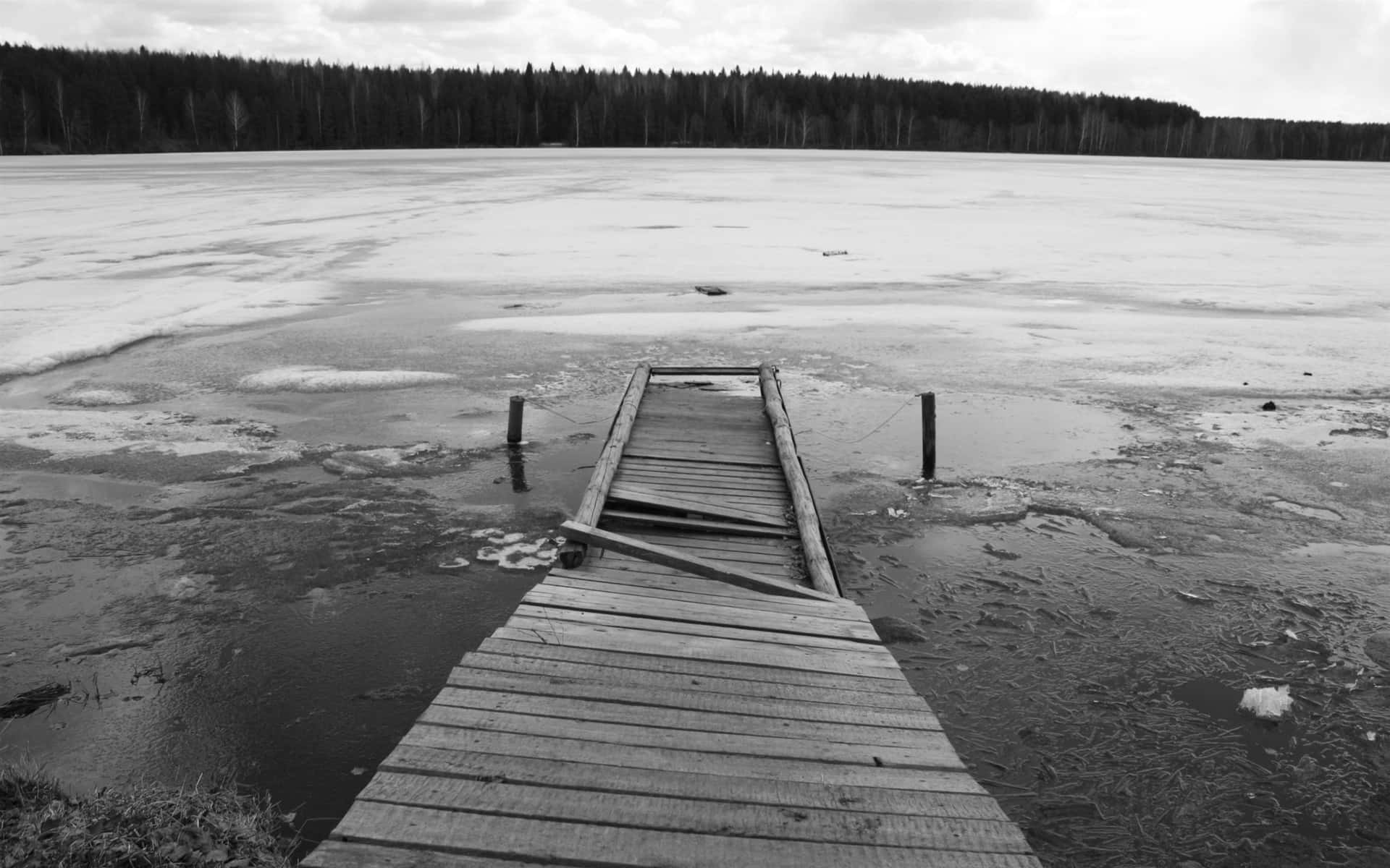 A Wooden Dock On A Frozen Lake