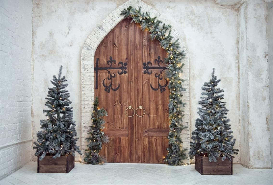 A Wooden Door With Two Christmas Trees In Front Of It Background
