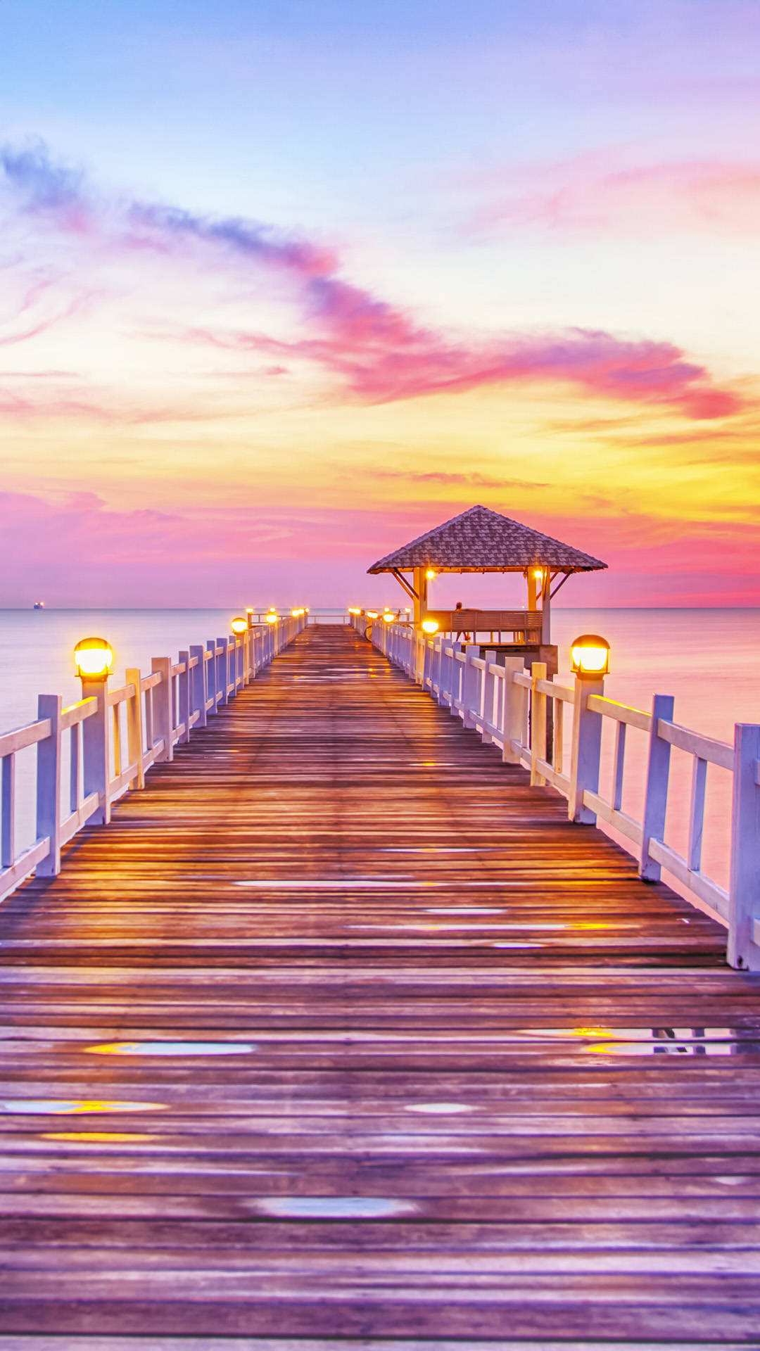 A Wooden Pier With A Sunset View Background