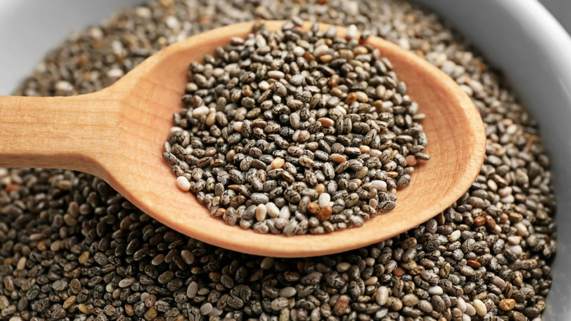 A Wooden Scoop Of Nutrient-dense Chia Seeds