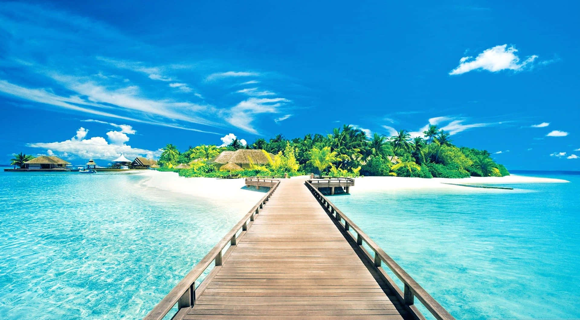 A Wooden Walkway Leading To An Island In The Ocean