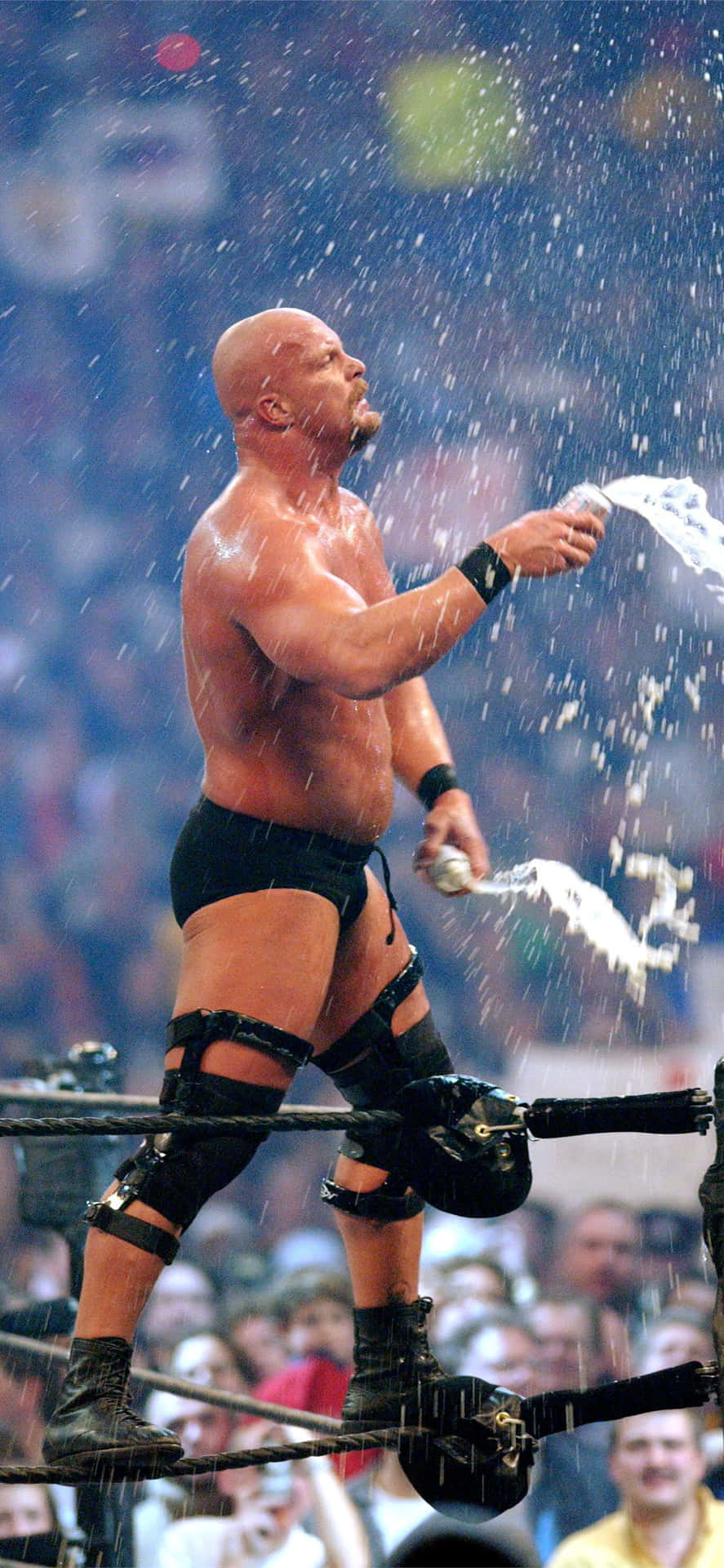 A Wrestler Is Spraying Water On A Crowd Background