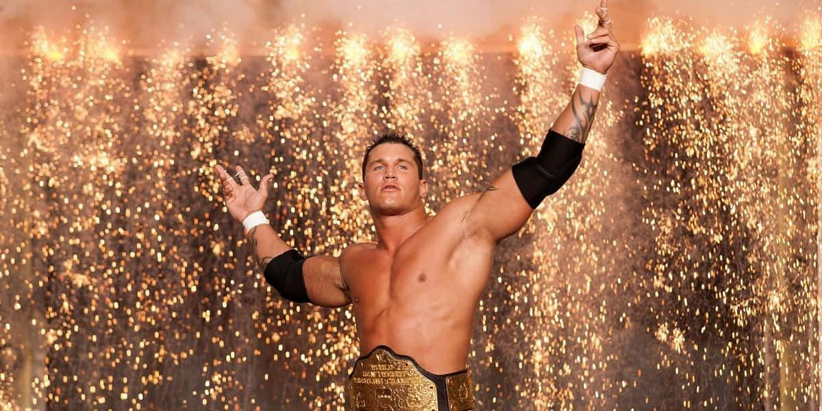 A Wrestler With His Hands Up In The Air Background