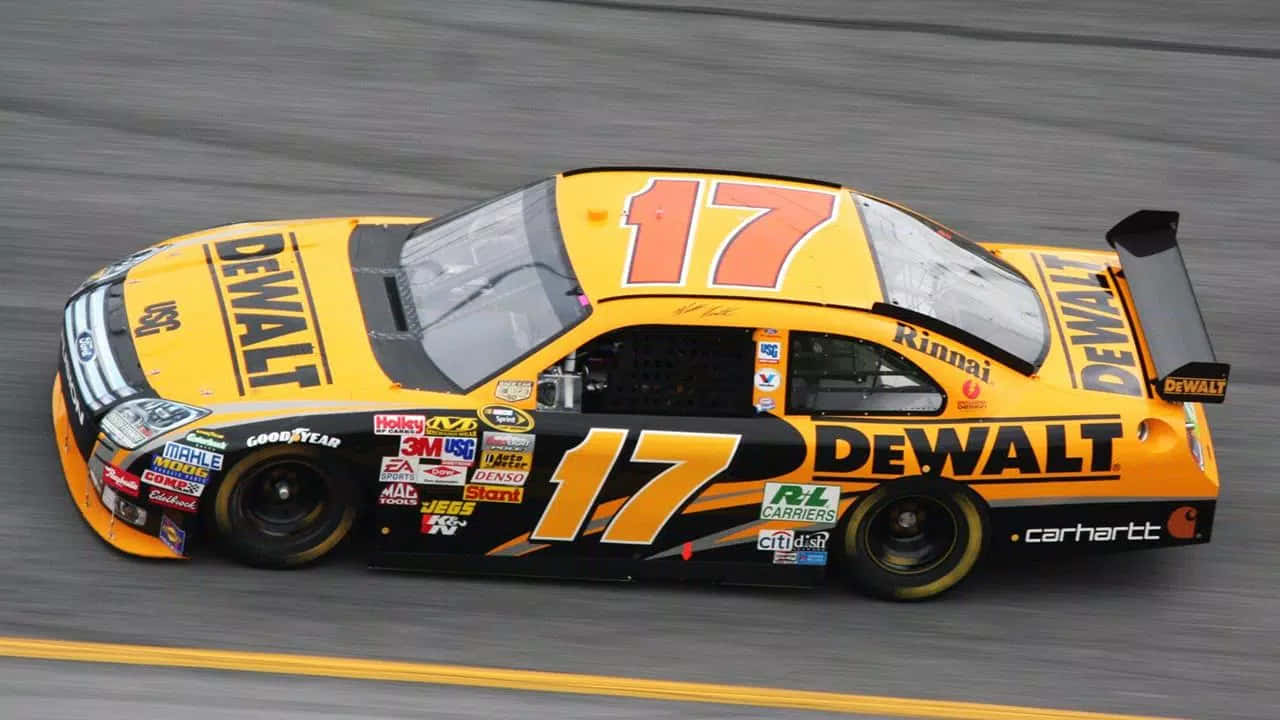 A Yellow And Black Nascar Car Driving On A Track Background