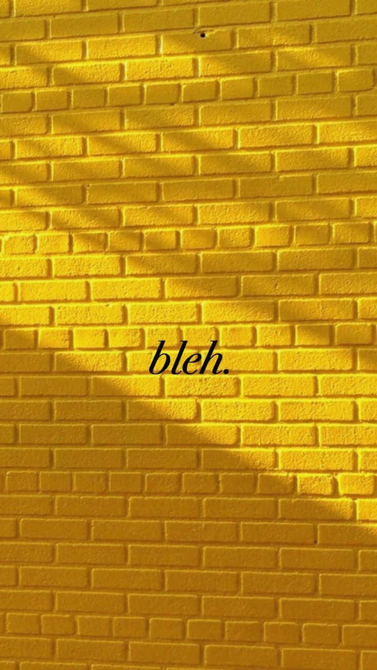 A Yellow Brick Wall With The Word Blh Background