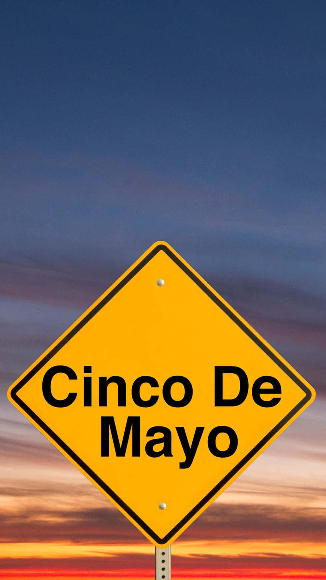 A Yellow Sign With A Blue Sky Background