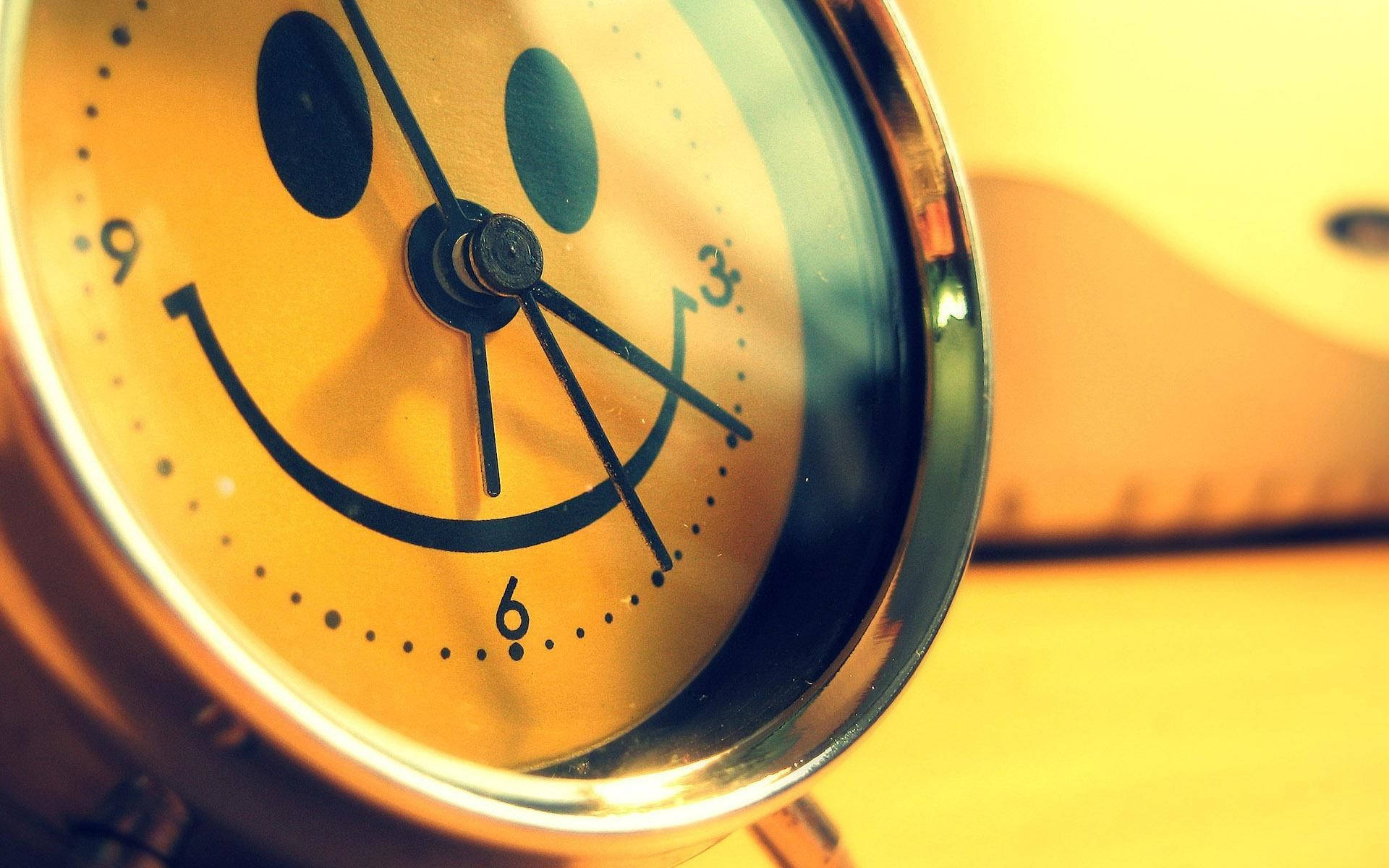 A Yellow Smiley Face Clock With A Cute Smile Background