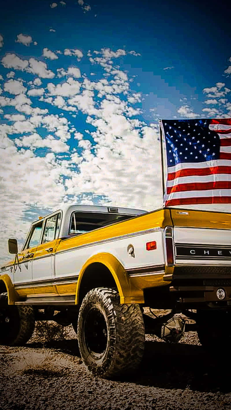 A Yellow Truck With An American Flag Background