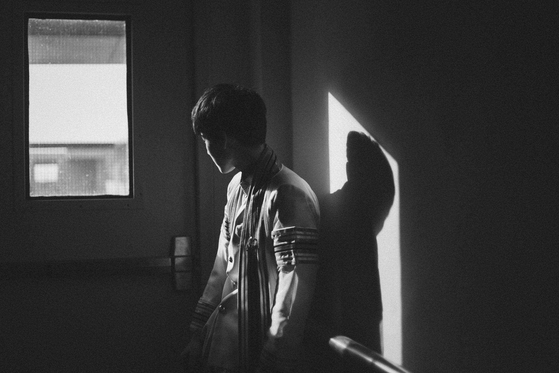 A Young Boy Looking Towards The Future Background