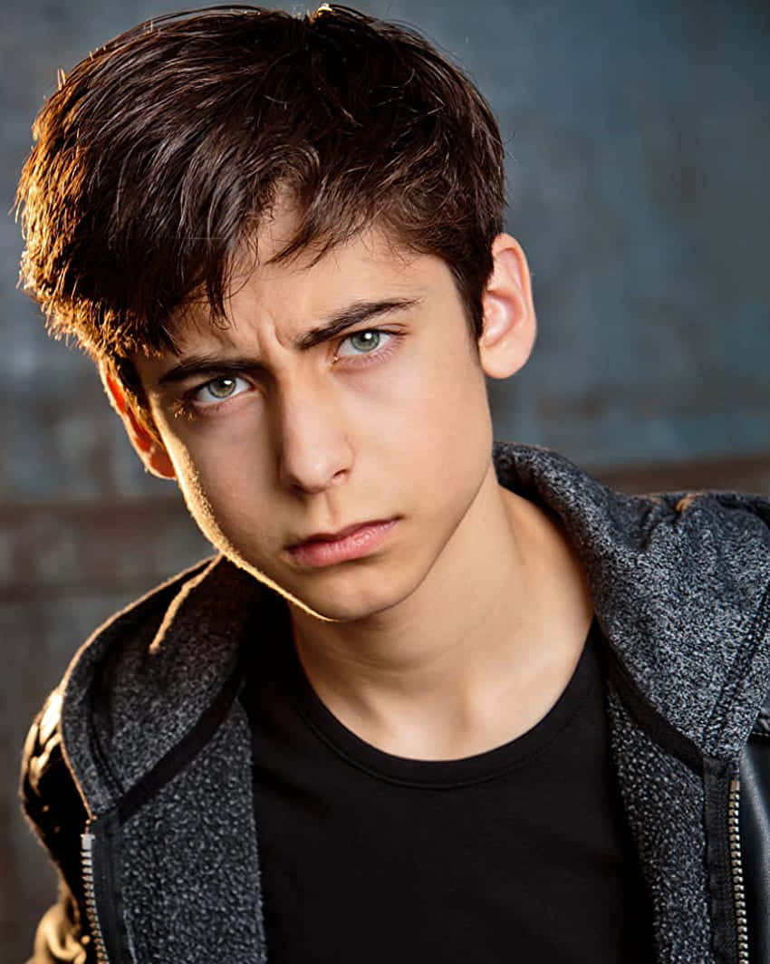 A Young Man In A Black Jacket And Black Pants Background