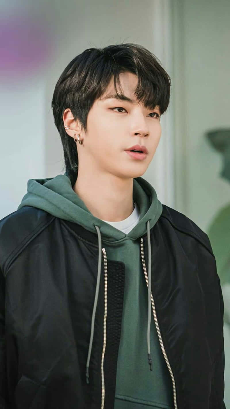 A Young Man In A Black Jacket And Green Hoodie Background