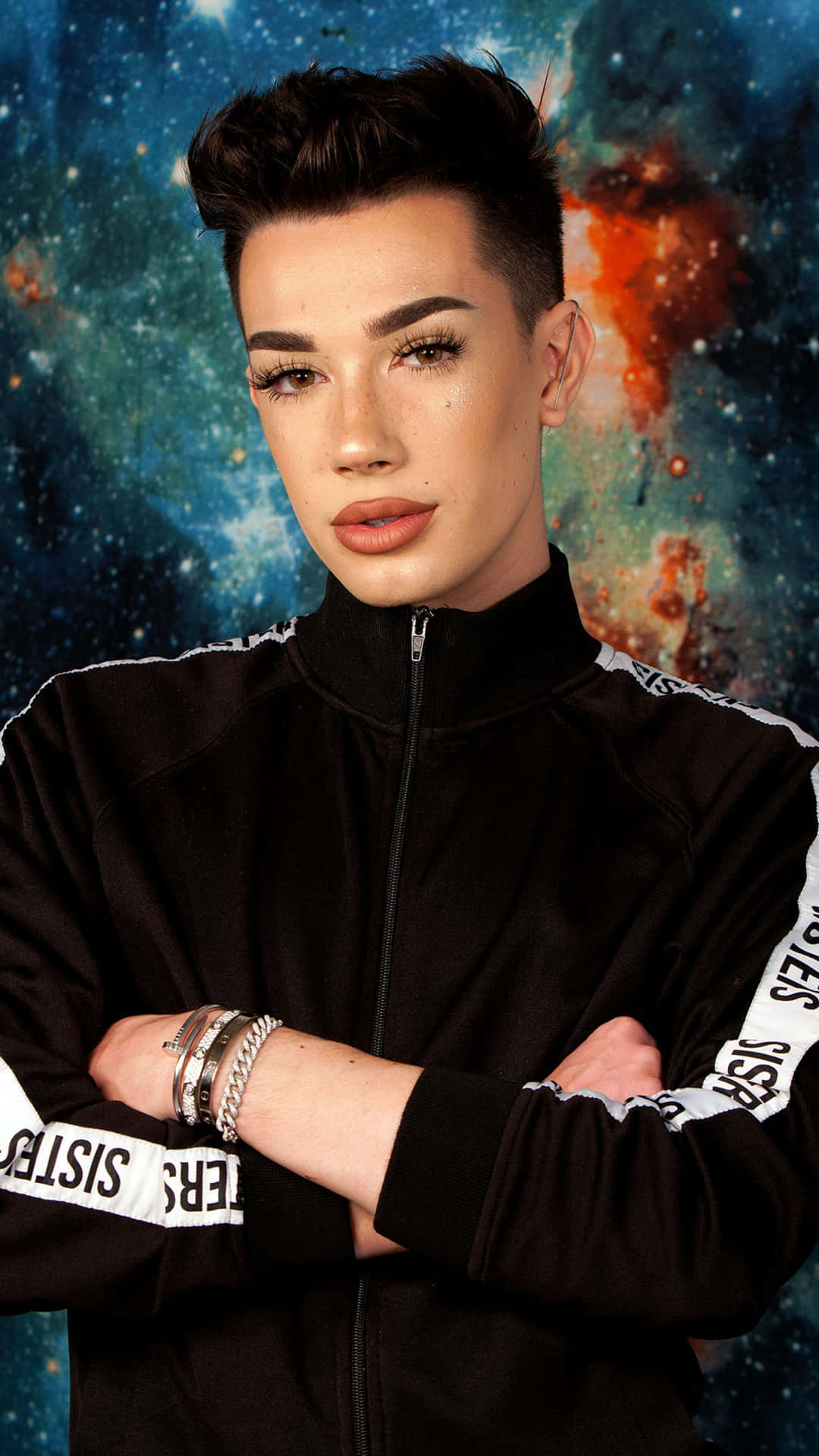 A Young Man In A Black Jacket Standing In Front Of A Space Background Background