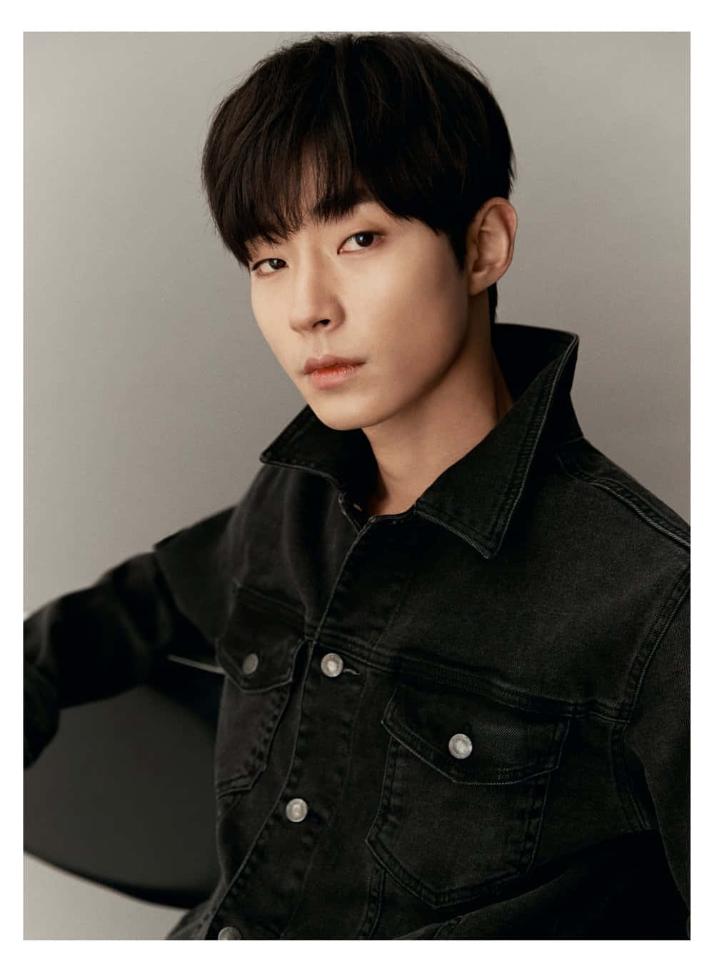 A Young Man In A Black Jacket Background