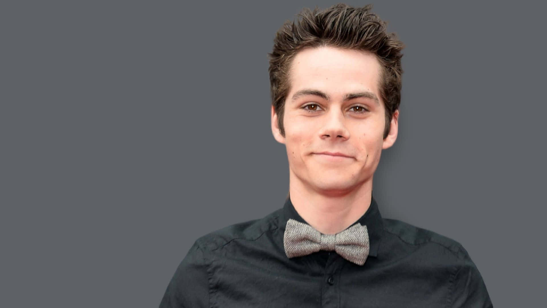 A Young Man In A Bow Tie Background