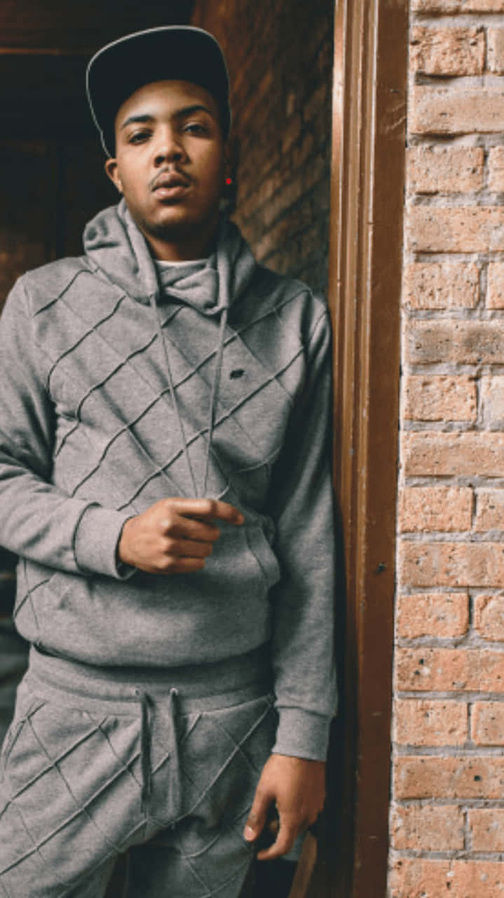 A Young Man In A Grey Hoodie And Tracksuit Background