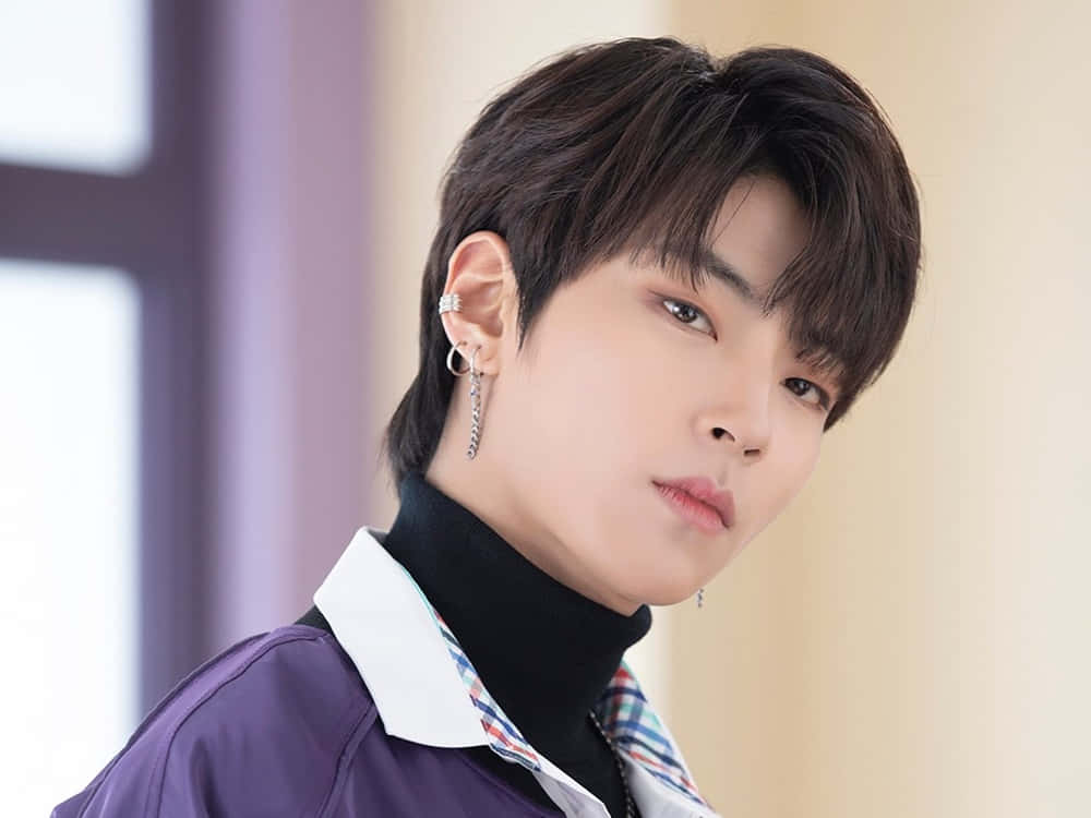 A Young Man In A Purple Shirt And Black Pants Background