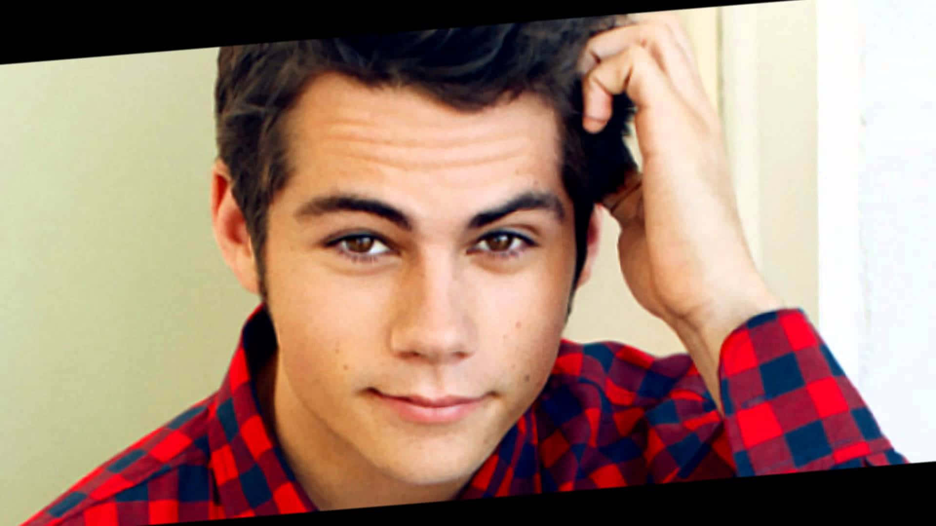 A Young Man In A Red And Black Plaid Shirt Background
