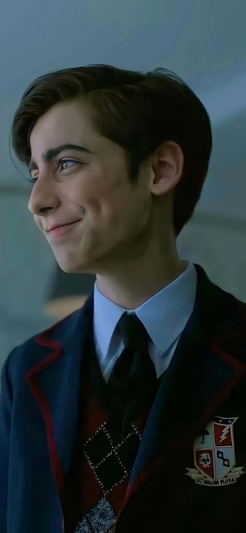 A Young Man In A School Uniform Is Smiling Background