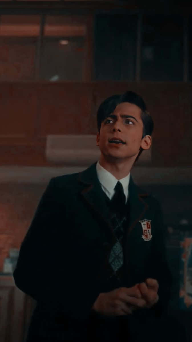 A Young Man In A Suit And Tie Is Standing In A Room Background