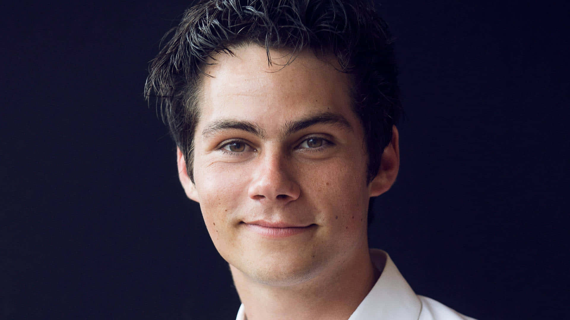 A Young Man In A White Shirt Is Smiling Background