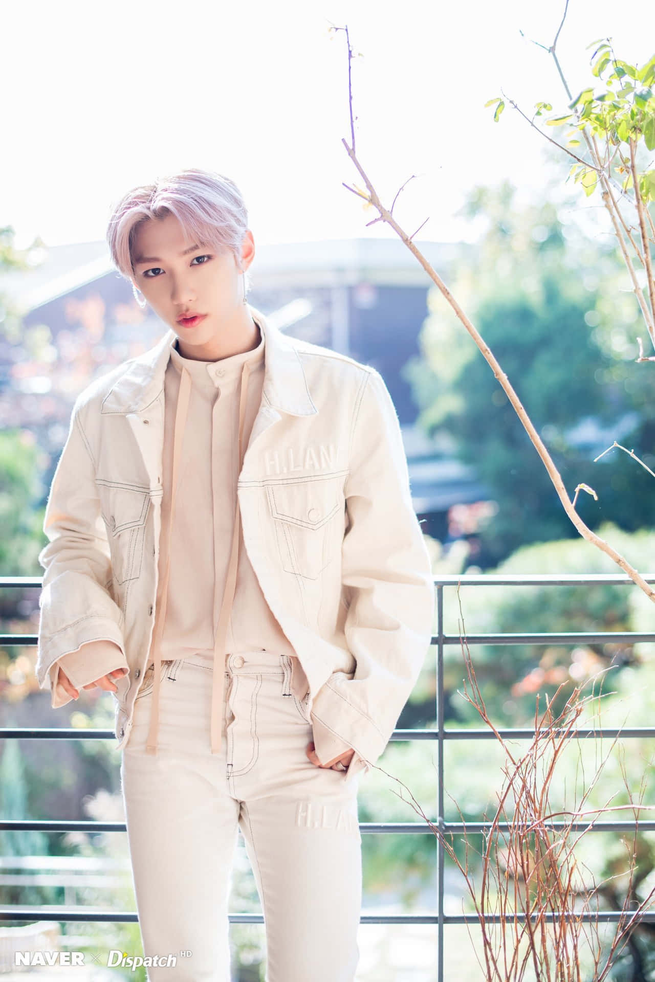 A Young Man In White Pants And A White Jacket Background