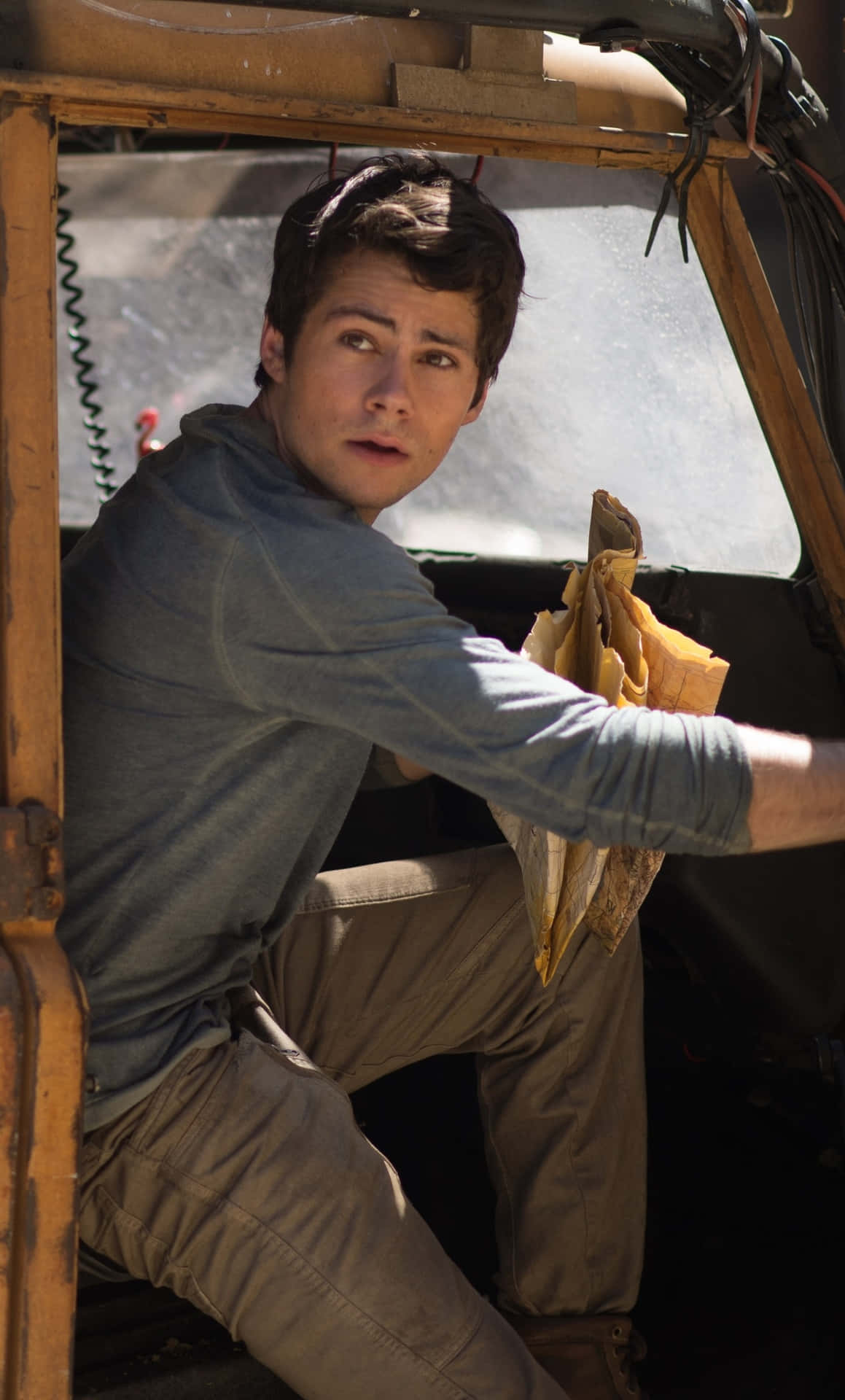 A Young Man Sitting In The Back Seat Of A Truck Background