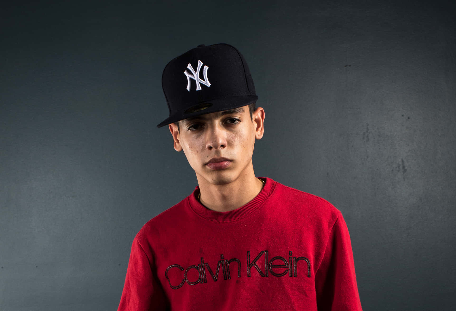 A Young Man Wearing A Hat Background