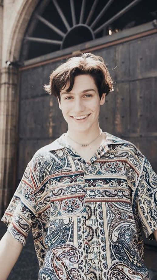A Young Man Wearing A Paisley Shirt