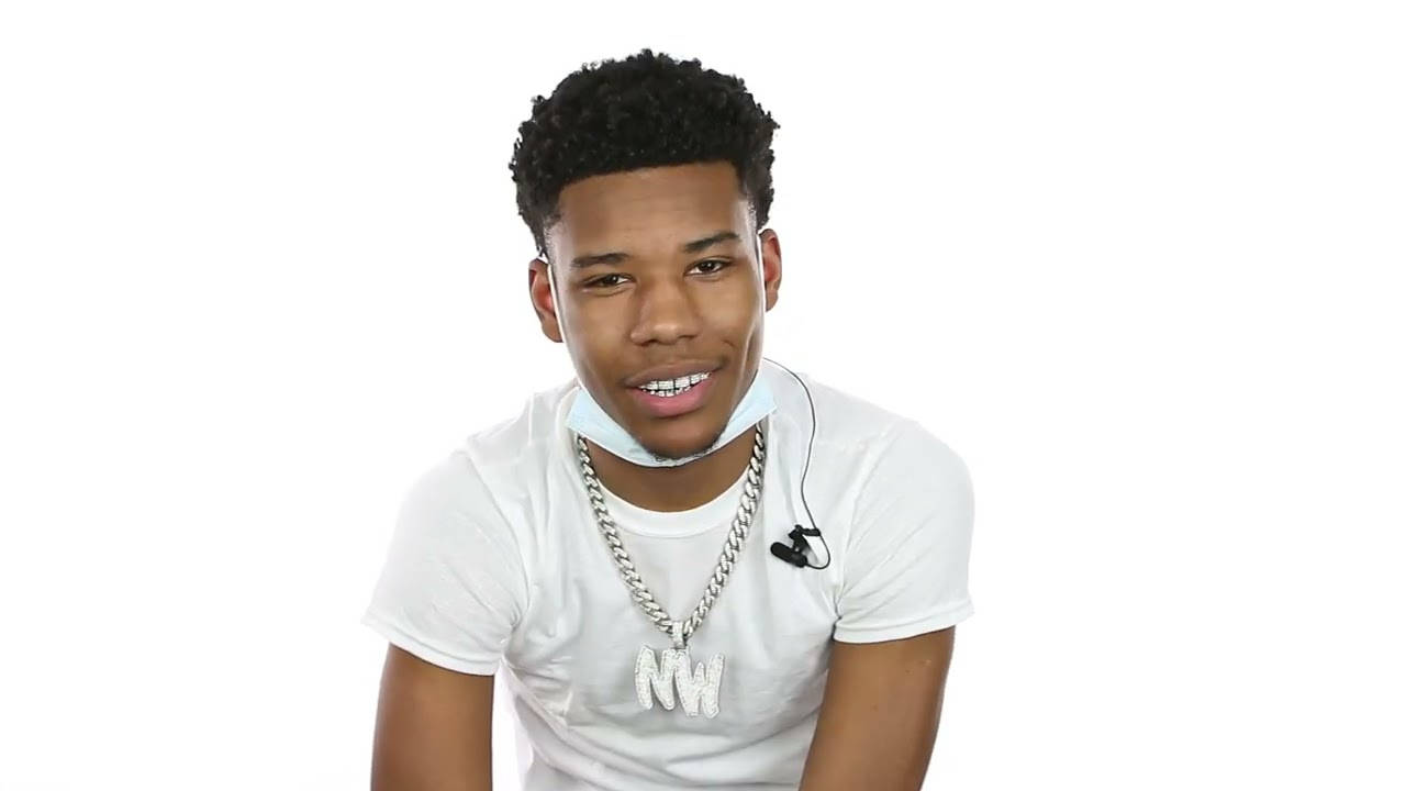 A Young Man Wearing A White Shirt And A Necklace Background