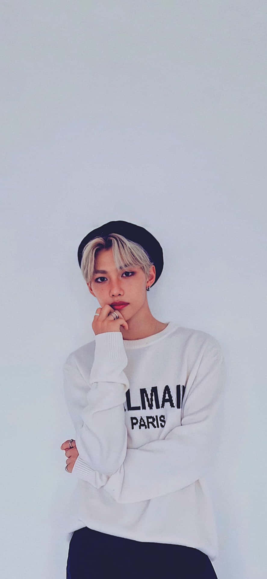 A Young Man Wearing A White Sweater And Hat Background