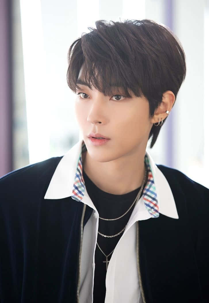 A Young Man With A Black Jacket And White Shirt Background