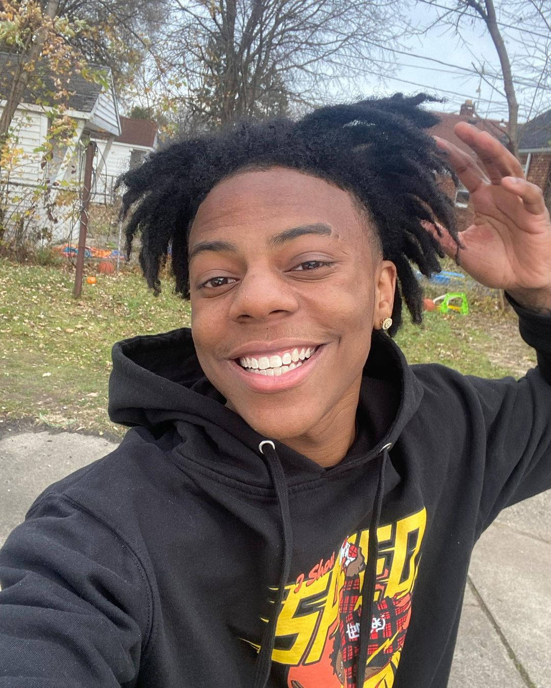 A Young Man With Afro Hair Is Smiling Background