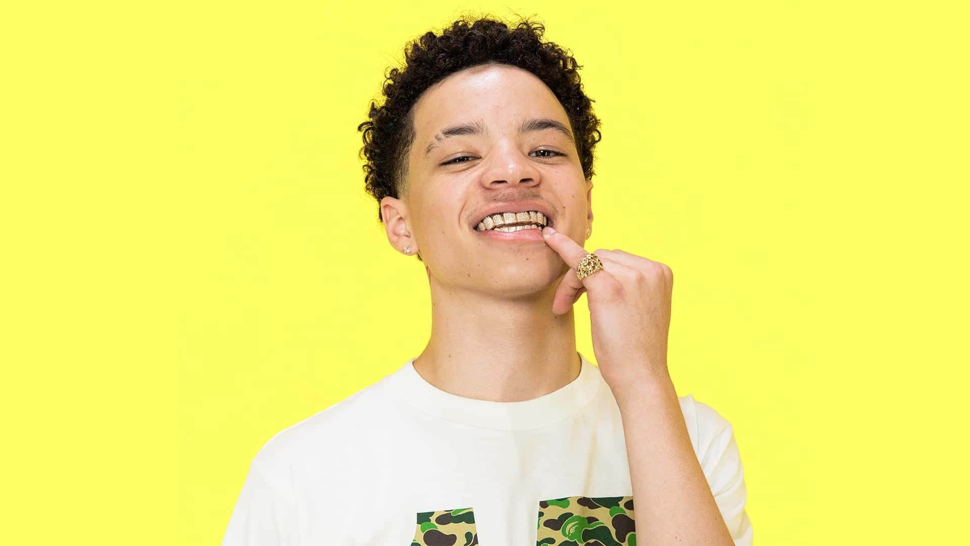 A Young Man With His Mouth Open Is Posing For A Photo