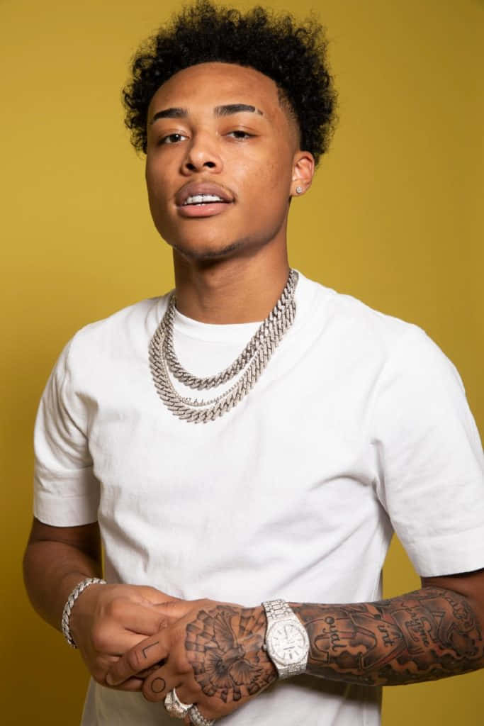 A Young Man With Tattoos And A White Shirt Background