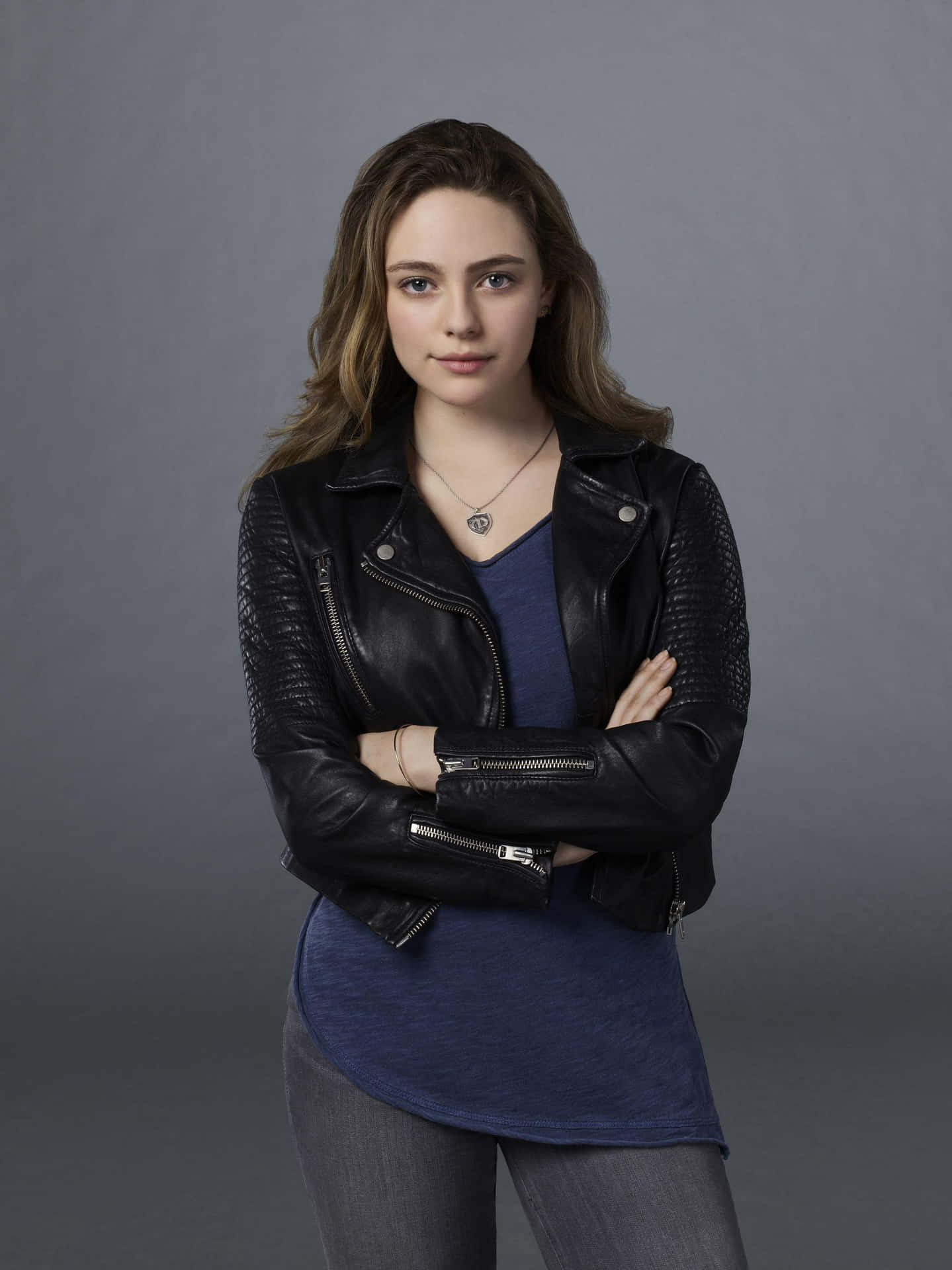 A Young Woman In A Black Leather Jacket Background