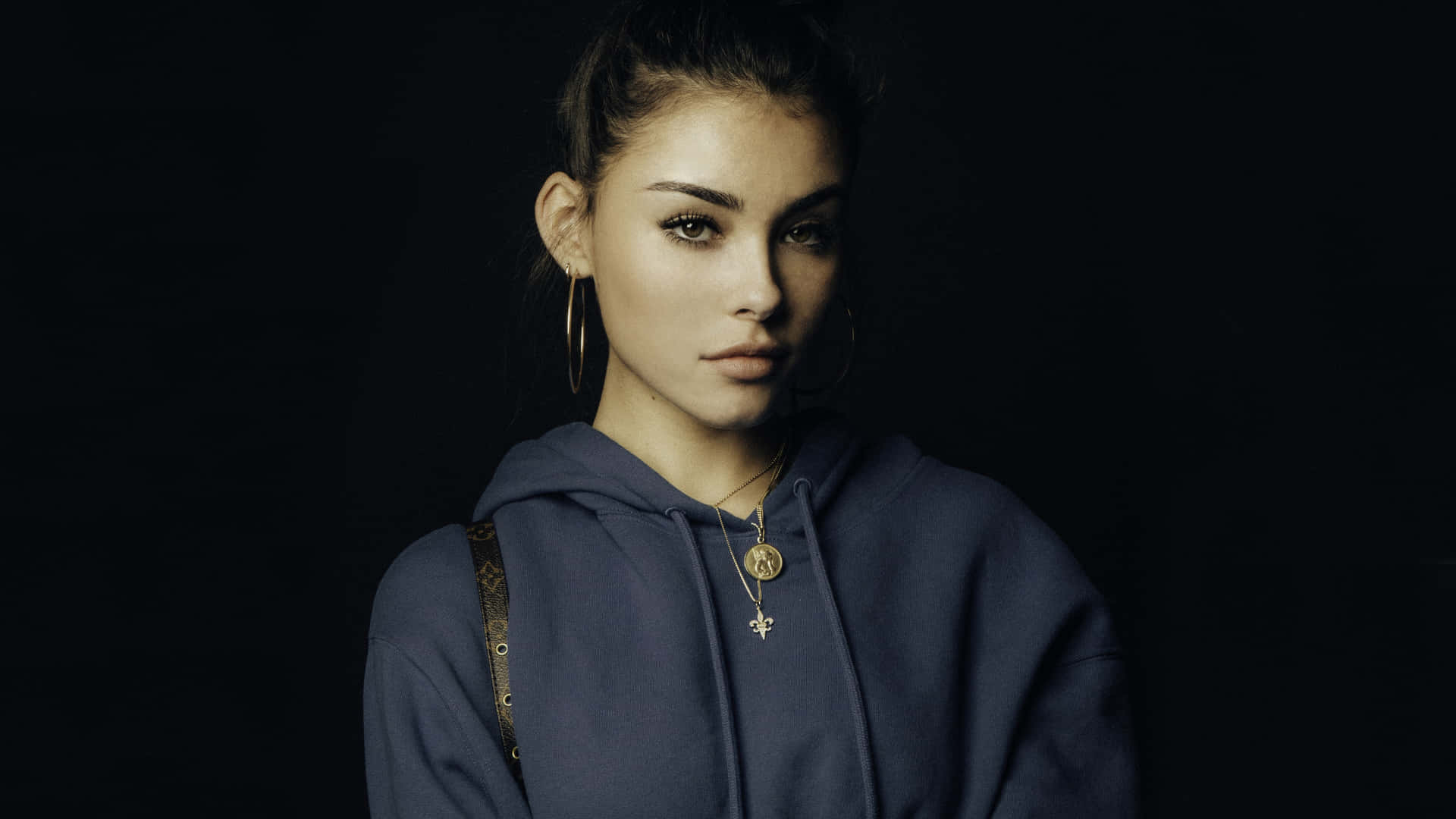 A Young Woman In A Blue Hoodie Posing For A Photo Background