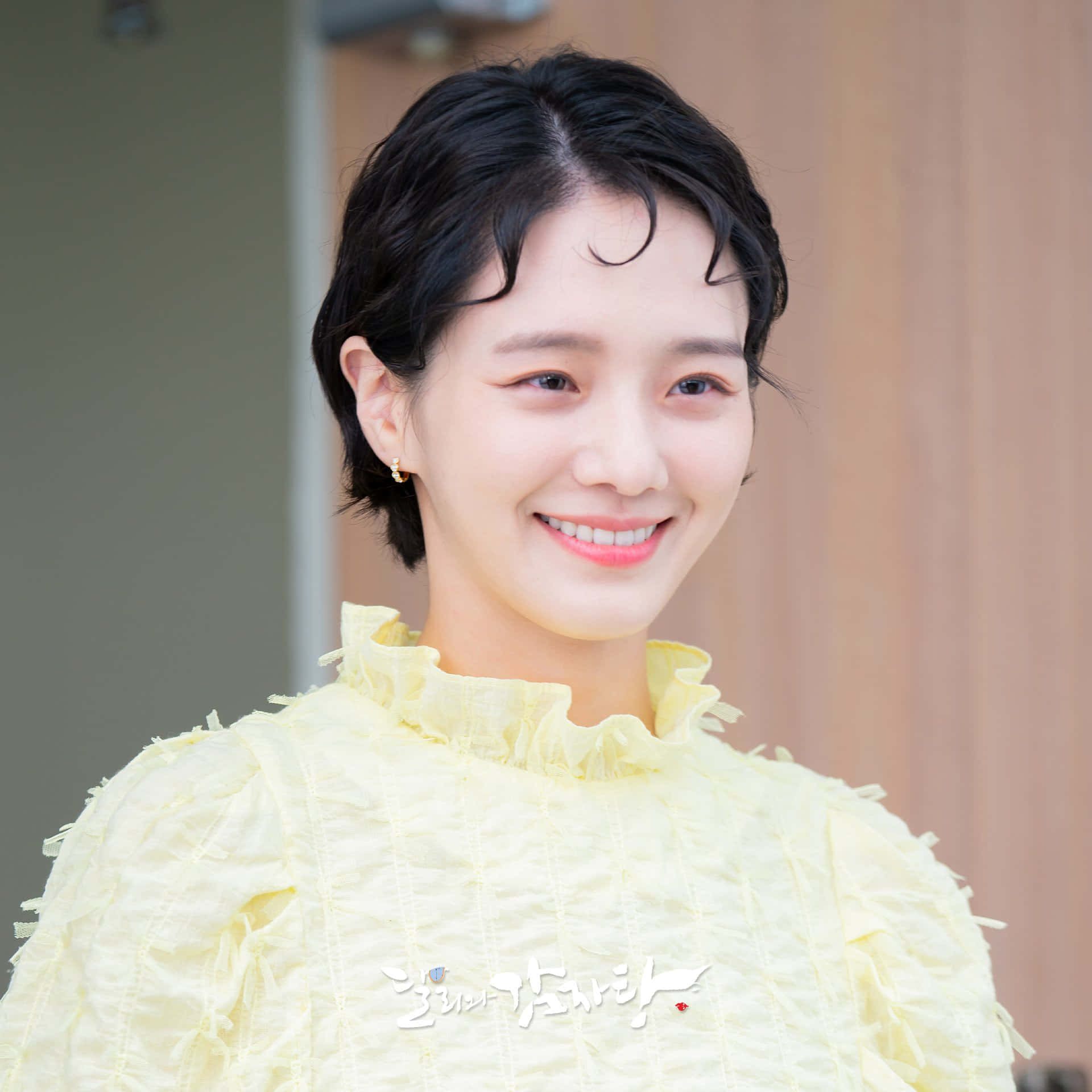 A Young Woman Smiling In A Yellow Dress Background